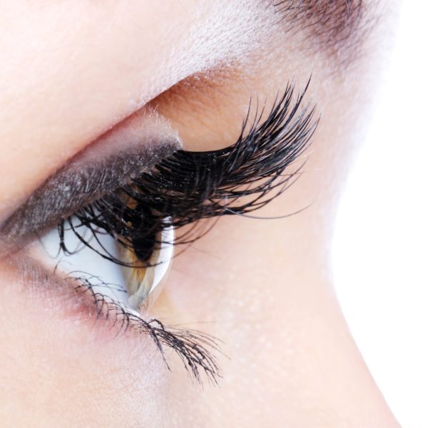 Profile view of a human eye with a long curl false eyelashes